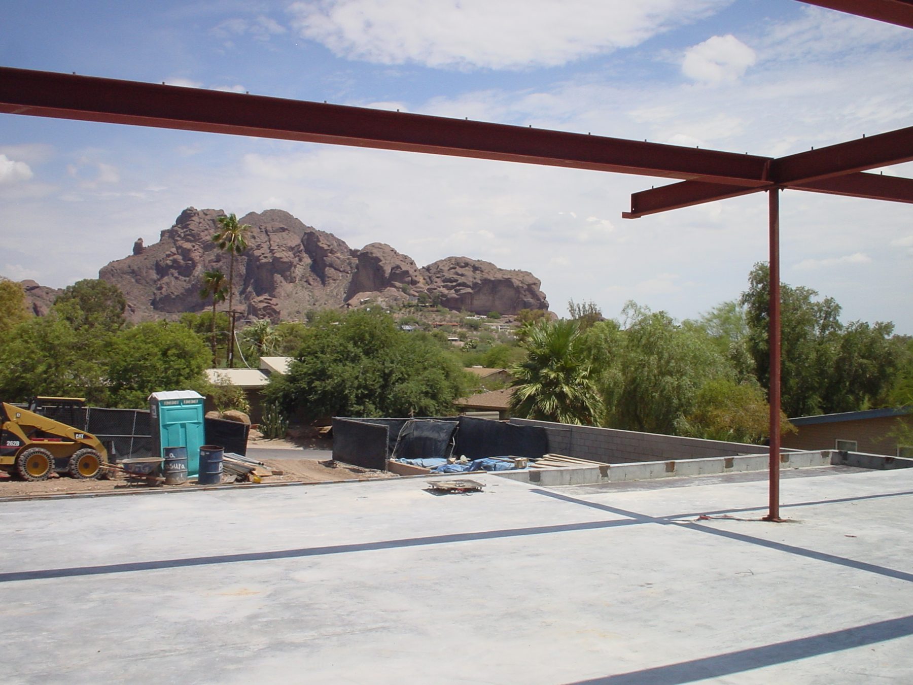 Steel frame rising over the concrete base, framing Camelback Mountain